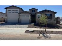 Charming single-Gathering home with a well-maintained front yard, two-car garage, and neutral color palette at 23777 N 165Th Dr, Surprise, AZ 85387