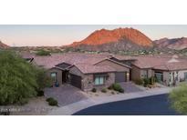 Beautiful desert home with brick driveway and stone accents, set against a majestic mountain backdrop at 26885 N 104Th Pl, Scottsdale, AZ 85262