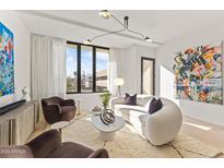 Bright living room featuring modern lighting, plush seating, and floor-to-ceiling windows at 312 E Windsor Ave # 6, Phoenix, AZ 85004
