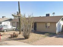 Charming single-story brick home featuring desert landscaping with gravel, cacti, and drought-resistant plants at 3227 W Lisbon Ln, Phoenix, AZ 85053