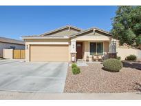 Charming single-story home with a two-car garage, low-maintenance landscaping, and inviting front porch at 5724 N 108Th Ave, Phoenix, AZ 85037