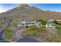 Expansive desert home featuring multiple buildings with modern architecture and lush landscaping at 6432 E El Sendero Rd, Carefree, AZ 85377