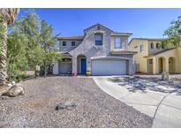 Two-story home with a well-manicured front yard and a blue front door at 1107 E La Salle St, Phoenix, AZ 85040