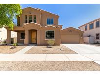 Charming two-story home with a tan exterior and a well-manicured front yard at 13617 W Crocus Dr, Surprise, AZ 85379