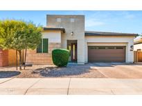 Inviting exterior featuring desert landscaping, a modern design and a two-car garage for easy parking at 1492 W Bruce Ave, Gilbert, AZ 85233