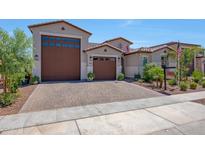 Stunning home showcasing a three-car garage, tile roof, and well-manicured landscaping at 17597 W Red Fox Rd, Surprise, AZ 85387