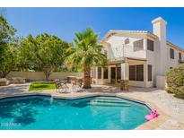 Beautiful backyard with a pool, palm tree, patio, and outdoor seating area at 1953 W Lark Dr, Chandler, AZ 85286