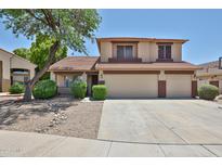 Charming two-story home featuring a three-car garage and well-maintained desert landscaping at 21141 N 79Th Ave, Peoria, AZ 85382