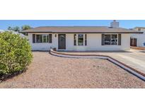 Charming single-story home featuring a well-maintained front yard and a decorative wreath on the front door at 2337 E Contessa St, Mesa, AZ 85213