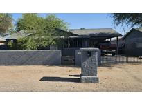 Charming home featuring a private front yard and a convenient carport at 265 W 17Th Ave, Apache Junction, AZ 85120