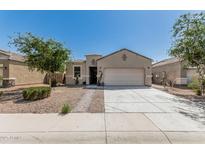 Charming single-story home featuring a two-car garage and low maintenance desert landscaping at 3112 N 303Rd Dr, Buckeye, AZ 85396