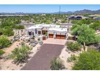 Stunning home featuring a desert landscape, a circular driveway, and a multi-car garage at 32826 N 54Th St, Cave Creek, AZ 85331