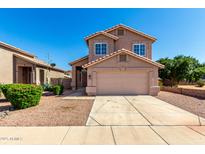 Two-story home featuring a two-car garage and well-maintained desert landscaping at 4031 W Lone Cactus Dr, Glendale, AZ 85308