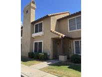 Charming two-story townhome featuring a tile roof and inviting front entrances at 4601 N 102Nd Ave # 1194, Phoenix, AZ 85037
