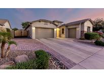 Charming home with three-car garage, stone accents, and well-manicured landscaping at 5607 W Alyssa Ln, Phoenix, AZ 85083
