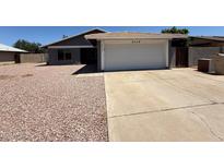 Charming single-story home features a two-car garage and low-maintenance desert landscaping at 5634 W Puget Ave, Glendale, AZ 85302