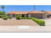 Inviting single-story home with a low-maintenance desert landscape and charming orange tile roof at 6017 E Kathleen Rd, Scottsdale, AZ 85254
