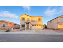 Charming two-story home with a two-car garage and desert landscaping at 6537 W Pioneer St, Phoenix, AZ 85043