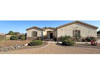 Charming single-story home featuring well-maintained landscaping and a welcoming entrance at 661 W Via De Palmas --, San Tan Valley, AZ 85140