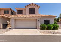 Charming home with a tile roof, attached garage, and well-maintained landscaping in a residential neighborhood at 7621 S Bonarden Ln, Tempe, AZ 85284