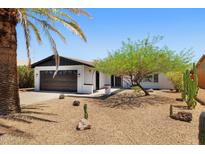 Charming single-story home with a well-kept yard, desert landscaping, and a two-car garage at 811 E Brown St, Phoenix, AZ 85020