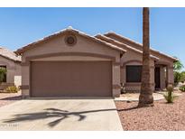 Charming single-story home featuring a two-car garage and desert landscaping at 8609 W Eva St, Peoria, AZ 85345