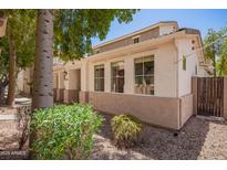 Charming two-story home with a stucco exterior, well-maintained landscaping, and a private gated entrance at 10062 E Isleta Ave, Mesa, AZ 85209