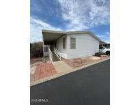 Exterior view of home with covered carport, stairway, and landscaped front at 11596 W Sierra Dawn Blvd # 372, Surprise, AZ 85378