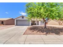 Charming single-story home with a two-car garage, mature tree, and low maintenance desert landscaping at 1858 S Ocotillo Dr, Apache Junction, AZ 85120
