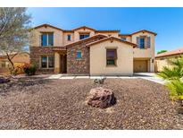 Beautiful two-story home featuring a low maintenance desert rock front yard and a charming desert landscape at 19415 W Colter St, Litchfield Park, AZ 85340