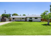 Charming single-story home with well-manicured lawn and updated neutral exterior paint at 215 W Ruth Ave, Phoenix, AZ 85021