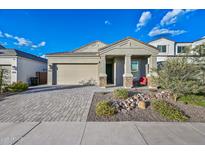 Attractive home features a welcoming front porch, a two-car garage, and low-maintenance landscaping at 2324 E Saguaro Park Ln, Phoenix, AZ 85024