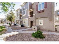 Attractive townhome complex featuring well-maintained landscaping and charming architectural details at 2401 E Rio Salado Pkwy # 1048, Tempe, AZ 85288