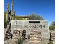 Monument sign for 24 North community surrounded by desert landscaping and beautiful Arizona sky at 2412 W Gloria Ln, Phoenix, AZ 85085