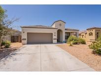 Charming home exterior featuring a two-car garage, low maintenance landscaping, and a welcoming entrance at 29481 W Mitchell Ave, Buckeye, AZ 85396