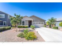 Charming single-story home boasts a neutral color, well-kept landscaping and a spacious two car garage at 36076 W Santa Barbara Ave, Maricopa, AZ 85138