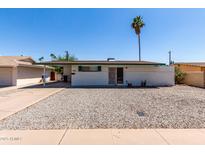 Charming single-story home featuring low-maintenance desert landscaping and a covered carport at 539 E Pebble Beach Dr, Tempe, AZ 85282