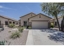 Charming single-story home with a well-manicured front yard and two-car garage at 549 E Quentin Ln, San Tan Valley, AZ 85140