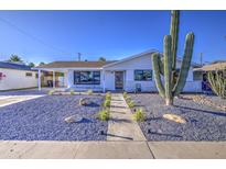 Charming single-story home featuring desert landscaping, a walkway, and a covered carport at 7428 E Cambridge Ave, Scottsdale, AZ 85257