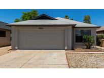 Charming single-story home featuring a two-car garage and well-maintained landscaping at 8720 W Willowbrook Dr, Peoria, AZ 85382