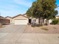Charming single-story home with a well-maintained front yard and a two car garage at 1595 S 227Th Ave, Buckeye, AZ 85326