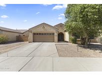 Charming single-story home with a two-car garage and a well-maintained landscaped front yard at 16762 W Sonora St, Goodyear, AZ 85338