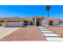 Charming home featuring a red tile roof, desert landscaping, and a welcoming front entrance at 17025 E De Anza Dr, Fountain Hills, AZ 85268
