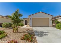 Charming single-story home featuring low maintenance landscaping and a two-car garage at 17444 W Via De Luna Dr, Surprise, AZ 85387