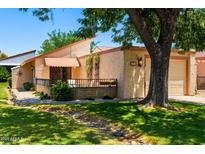 Charming single-story home featuring an attached garage, inviting entrance, and mature landscaping at 212 Leisure World --, Mesa, AZ 85206