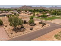 Expansive property featuring a single-story home, mature trees, and picturesque mountain views at 22201 E Vallejo St, Queen Creek, AZ 85142
