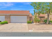 Charming home featuring a two-car garage, desert landscaping, and a classic red tile roof under a sunny sky at 3510 E Hampton Ave # 18, Mesa, AZ 85204