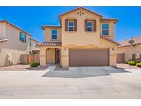 Inviting two-story home featuring a well-kept yard, two-car garage and appealing desert landscape at 5113 E Greenway E St, Mesa, AZ 85205