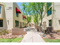 Attractive condo complex with red awnings, walkway, desert landscaping, and verdant trees at 620 N 4Th Ave # 10, Phoenix, AZ 85003