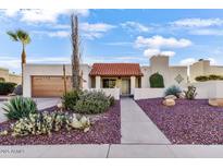 Charming single-story home featuring desert landscaping and a terracotta tile roof at 7610 N Via De Manana Dr, Scottsdale, AZ 85258
